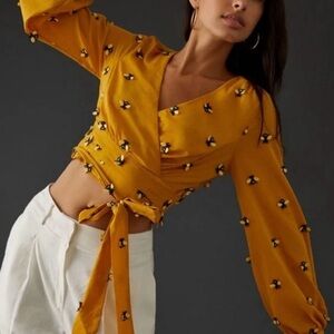 Anthropologie Maeve long-sleeve wrap top in yellow with bee embellishments